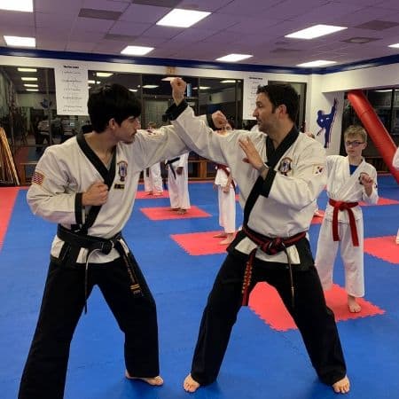 Teen students practicing martial arts technique